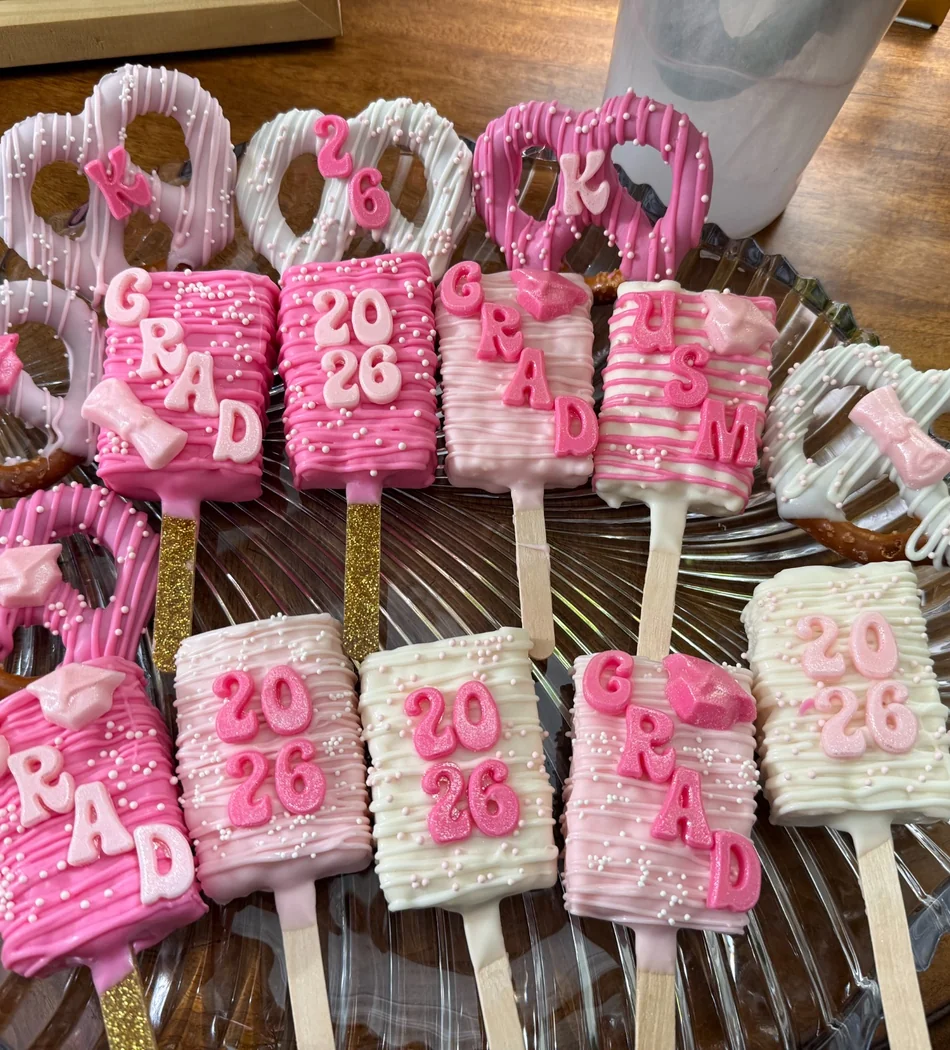 Close-up of custom pink graduation treats