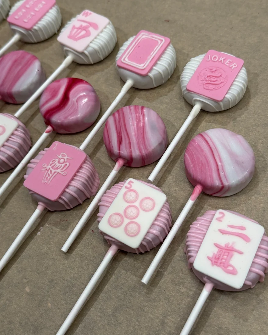 Close-up of pink mahjong tile cake pops and marbled pops
