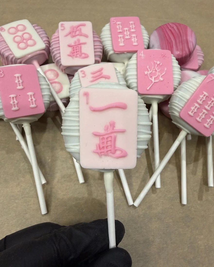Detailed mahjong tile cake pop in soft pink and white